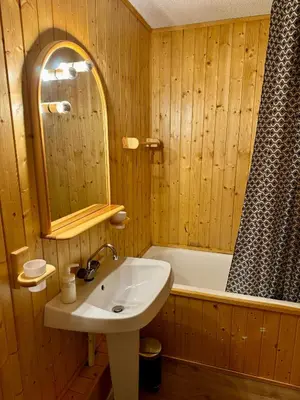 a bathroom with a sink and a bath tub at Les Airelles 402 in Arâches-la-Frasse