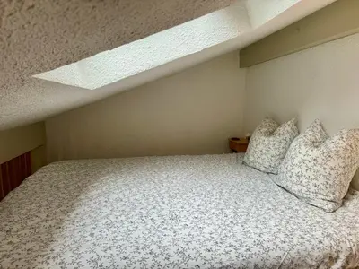 a bedroom with a bed with pillows on it at Les Airelles 402 in Arâches-la-Frasse