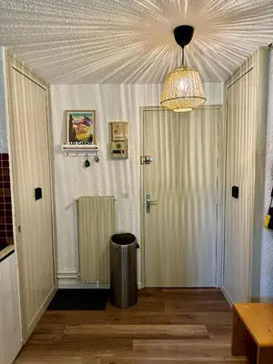 a hallway with a door and a ceiling at Les Airelles 402 in Arâches-la-Frasse