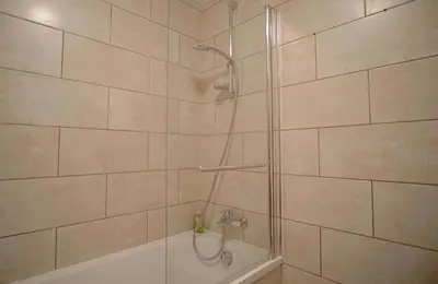 a shower with a glass door and a tub at La Terrasse- Panoramique- Familial-Près des pistes in Les Houches