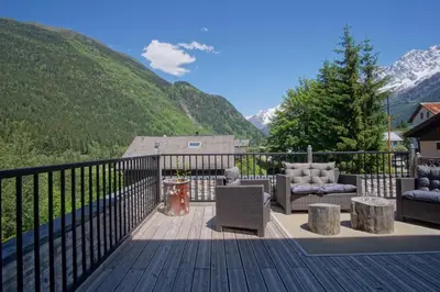 a deck with a view of a mountain at La Terrasse- Panoramique- Familial-Près des pistes in Les Houches