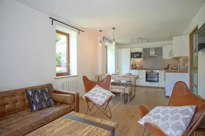 a living room with a couch and a table at La Terrasse- Panoramique- Familial-Près des pistes in Les Houches