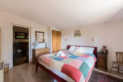 a bedroom with a bed with a colorful comforter at Chalet l'Arba - Ecrin à la croisée des stations in Cordon