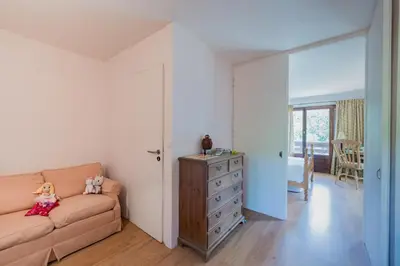 a living room with a couch and a dresser at Chalet l'Arba - Ecrin à la croisée des stations in Cordon
