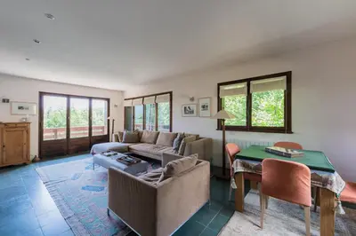 a living room with a couch and a table at Chalet l'Arba - Ecrin à la croisée des stations in Cordon