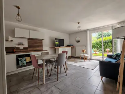 a kitchen and living room with a table and chairs at Appartement avec jardin in Saint-Gervais-les-Bains