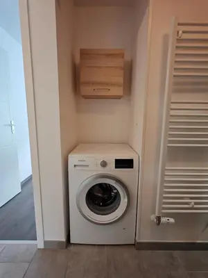 a washer and dryer in a small room at Appartement avec jardin in Saint-Gervais-les-Bains