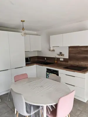 a kitchen with a table and chairs in a room at Appartement avec jardin in Saint-Gervais-les-Bains