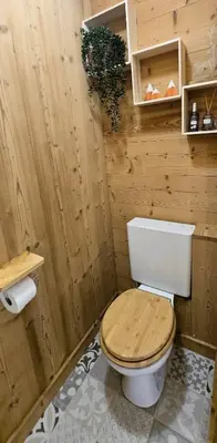 a wooden bathroom with a toilet in a room at Joli studio avec terrasse in Sallanches