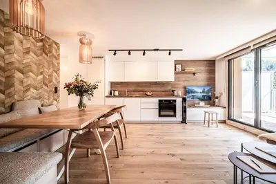 a kitchen and dining room with a wooden table at Apartment Houchma Les Houches - by EMERALD STAY in Les Houches