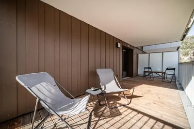 two chairs and a table on a deck at Apartment Houchma Les Houches - by EMERALD STAY in Les Houches