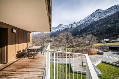 a balcony with a table and a view of mountains at Apartment Houchma Les Houches - by EMERALD STAY in Les Houches