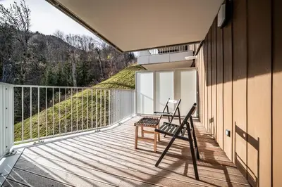 two chairs on the balcony of a house at Apartment Houchma Les Houches - by EMERALD STAY in Les Houches