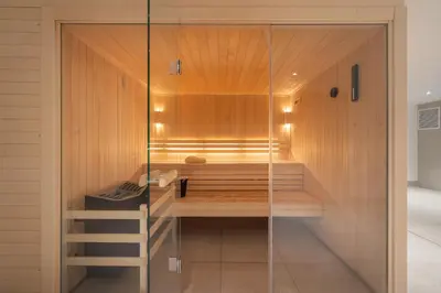 a glass shower in a bathroom with a bench at Apartment Houchma Les Houches - by EMERALD STAY in Les Houches
