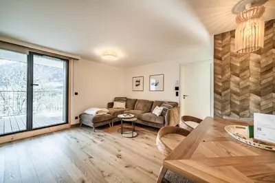 a living room with a couch and a table at Apartment Houchma Les Houches - by EMERALD STAY in Les Houches