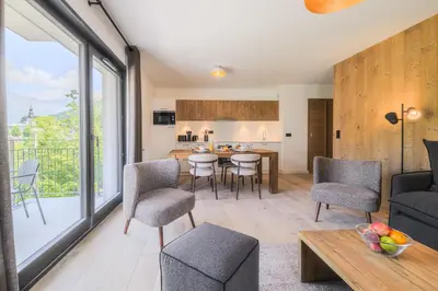 a living room with a couch and a table at TERRESENS - Les Sources de Canopée in Saint-Gervais-les-Bains