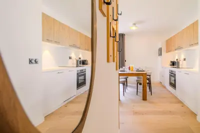 a kitchen with a table and a dining room at TERRESENS - Les Sources de Canopée in Saint-Gervais-les-Bains