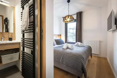 a bedroom with a bed and a window at TERRESENS - Les Sources de Canopée in Saint-Gervais-les-Bains
