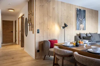 a dining room with a table and a couch at TERRESENS - Les Sources de Canopée in Saint-Gervais-les-Bains