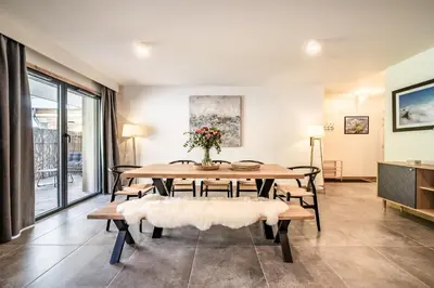 a dining room with a table and benches at Apartment Mathilde Les Houches - by EMERALD STAY in Les Houches