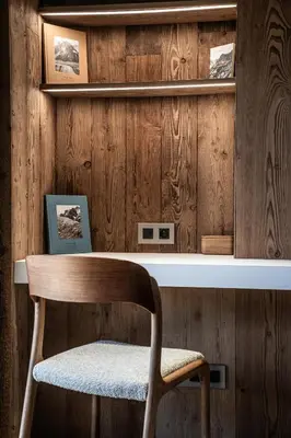 a bedroom with a large bed with wooden walls at Chalet Foxden in Les Houches