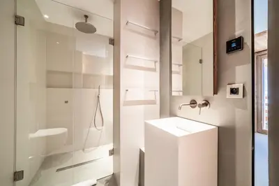 a glass shower in a bathroom with wooden ceilings at Chalet Foxden in Les Houches