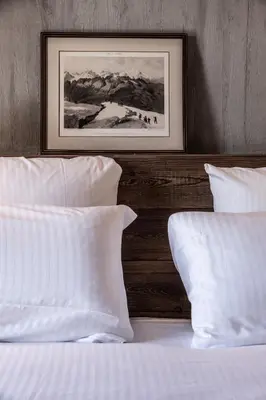 a kitchen with white cabinets and a wooden ceiling at Chalet Foxden in Les Houches