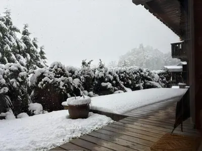 a snow covered yard with a bench and trees at 3 Bed Apartment with Private Terrace, Communal Pool, Mont Blanc Views in Saint-Gervais-les-Bains