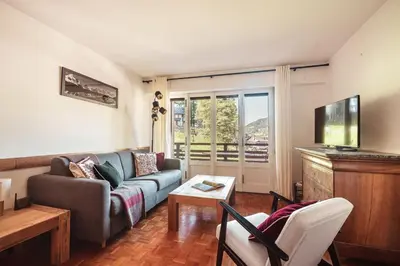 a living room with a couch and a table at Le Central - In the heart of Megève in Megève