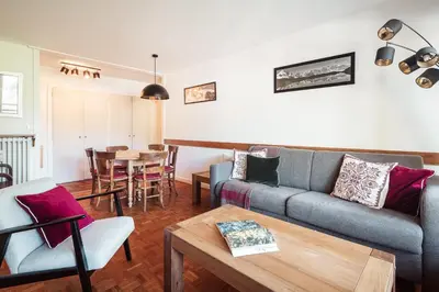 a living room with a couch and a table at Le Central - In the heart of Megève in Megève