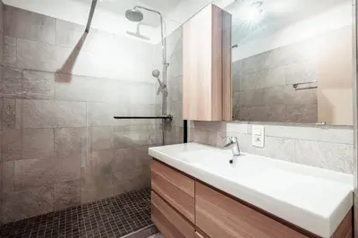 a bathroom with a sink and a shower at Le Central - In the heart of Megève in Megève