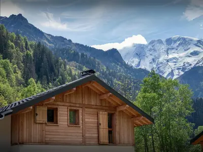 a bedroom with a large bed and a window at Chalet Ormiages - OVO Network in Saint-Gervais-les-Bains