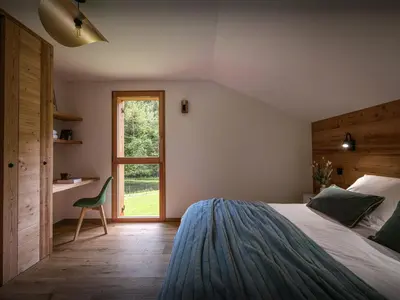 a bedroom with two beds and a window at Chalet Ormiages - OVO Network in Saint-Gervais-les-Bains