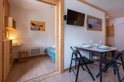 an apartment building with mountains in the background at Joli appartement Aiguille du Midi in Chamonix-Mont-Blanc