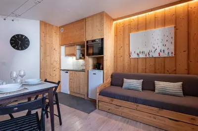 a living room with a couch and a table at Joli appartement Aiguille du Midi in Chamonix-Mont-Blanc