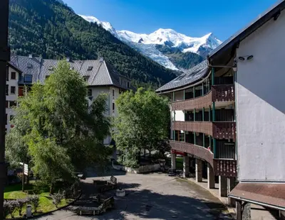 a view of a town with mountains in the background at Joli appartement Aiguille du Midi in Chamonix-Mont-Blanc