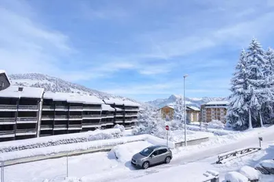 a car parked in a parking lot in front of a building at Studio with WiFi at the foot of the slopes in Megève