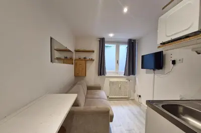 a small living room with a couch and a kitchen at Studio with WiFi at the foot of the slopes in Megève
