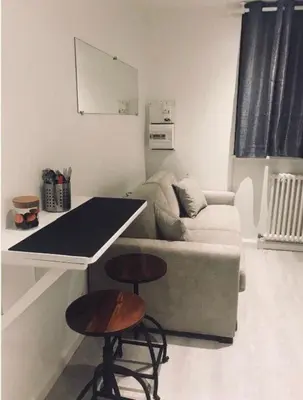 a living room with a couch and a table at Studio with WiFi at the foot of the slopes in Megève