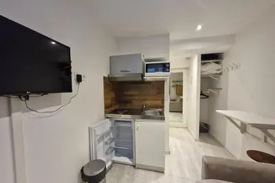 a small kitchen with a sink and a tv on a wall at Studio with WiFi at the foot of the slopes in Megève