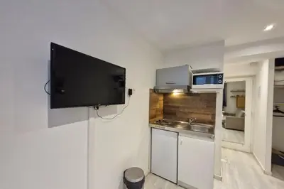 a kitchen with a flat screen tv on a wall at Studio with WiFi at the foot of the slopes in Megève