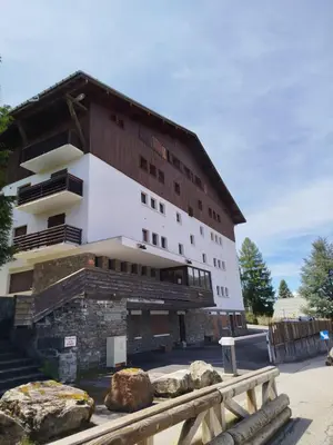 a large building with rocks in front of it at Studio with WiFi at the foot of the slopes in Megève