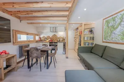 a kitchen with a living room and a dining room at Résidence Grand Roc - Bruyères 221 - Happy Rentals in Chamonix-Mont-Blanc