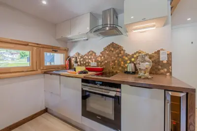 a dining room with a table and chairs at Résidence Grand Roc - Bruyères 221 - Happy Rentals in Chamonix-Mont-Blanc