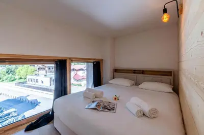 a living room with a couch and a table at Résidence Grand Roc - Bruyères 221 - Happy Rentals in Chamonix-Mont-Blanc