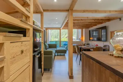 a living room with a couch and a table at Résidence Grand Roc - Bruyères 221 - Happy Rentals in Chamonix-Mont-Blanc
