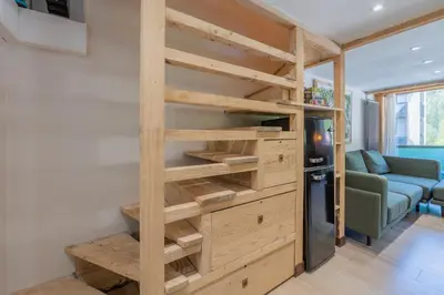 a living room with a couch and a large window at Résidence Grand Roc - Bruyères 221 - Happy Rentals in Chamonix-Mont-Blanc