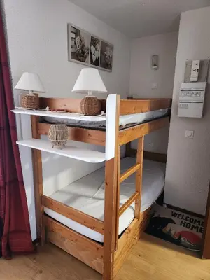 a bunk bed with two lamps on top of it at SamoensDt in Samoëns