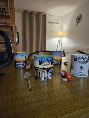 a table with three cups and a spoon on it at SamoensDt in Samoëns