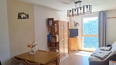 a living room with a table and a window at SamoensDt in Samoëns